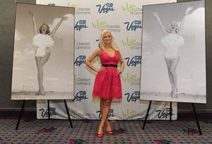 Holly Madison at a press conference at the Las Vegas Convention Center with the original Miss Atomic Bomb photograph, left, and her re-creation.