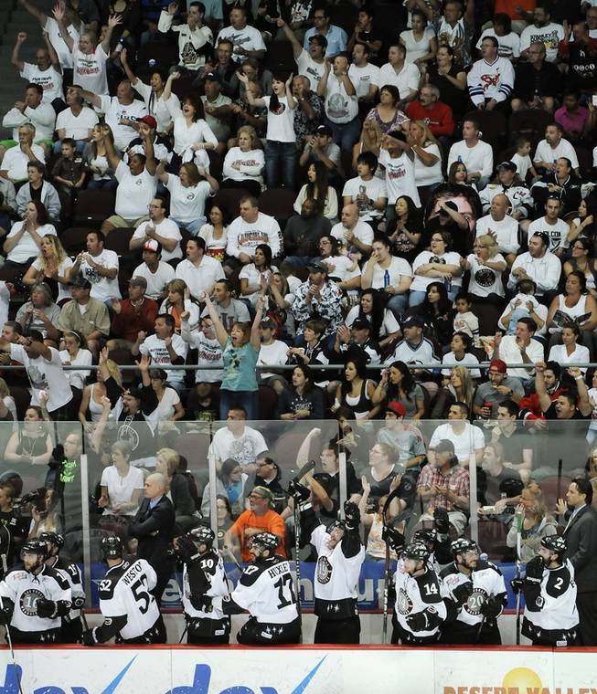 Wrangler fans clad in white erupt as players on the Las Vegas bench celebrate a second period goal scored by Eric Lampe during Game 1 of the Kelly Cup Finals at the Orleans Arena on Monday night.