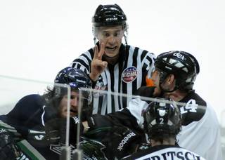 ECHL referee TJ Luxmore dishes out a two-minute penalty as players skuffle in front of him near the end of the second period of Game 1 of the Kelly Cup Finals at the Orleans Arena on Monday night.