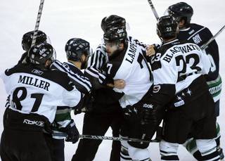 The Wranglers top line of Adam Miller, left, Eric Lampe, center, and Judd Blackwater is restrained by on-ice officials as their frustration shows against the Florida Everblades in Game 2 of the Kelly Cup Finals on Wednesday night.