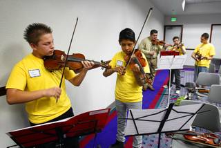 Von Tobel Middle School students Jovany Castanon, left, and Marcelino Cruz practice during a mariachi workshop led by members of Mariachi Cobre at Cashman Field Center Thursday, May 17, 2012. The students and Mariachi Cobre, from Walt Disney World's Epcot Center, will perform in the Las Vegas Latin Chamber of Commerce Mariachi Festival at the Smith Center for the Performing Arts Friday, May 18. 
