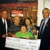 Dennis Hart and his wife Margaret (back center) stand with a $1 million check he won at the Flamingo on May 12, 2012.  With them are casino shift manager Bobby Harris (left), vice president of table games Mark Kelly (right) and their daughter Heather Hart (front).