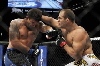 Frank Mir, left, of Las Vegas battles with heavyweight champion Junior dos Santos of Brazil during UFC 146 at the MGM Grand Garden Arena Saturday, May 26, 2012.