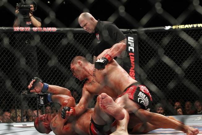 Cain Velasquez, right, of San Jose, Calif. pounds a bloodied Antonio Silva of Brazil during UFC 146 at the MGM Grand Garden Arena Saturday, May 26, 2012.