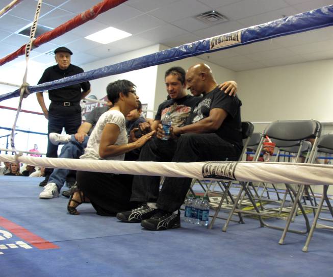 Arturo Martinez-Sanchez, center, sits next to Richard Steele, right, and talks to a fundraiser attendee. Steele organized a fundraiser Saturday afternoon during a boxing event at the Richard Steele Gym and Boxing Club, 2475 W. Cheyenne Ave. in North Las Vegas.
