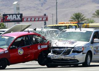 Accident reconstruction expert Rusty Haight crashes a van into another car during car crash testing at the Las Vegas Motor Speedway Monday, June 4, 2012. The tests, conducted by the Collision Safety Institute Crash Testing Team, were held in conjunction with the 11th annual ARC-CSI Crash Conference.