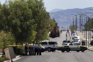 Officials investigate a fatal shooting on Windmill Parkway in Henderson June 6, 2012. STEVE MARCUS
