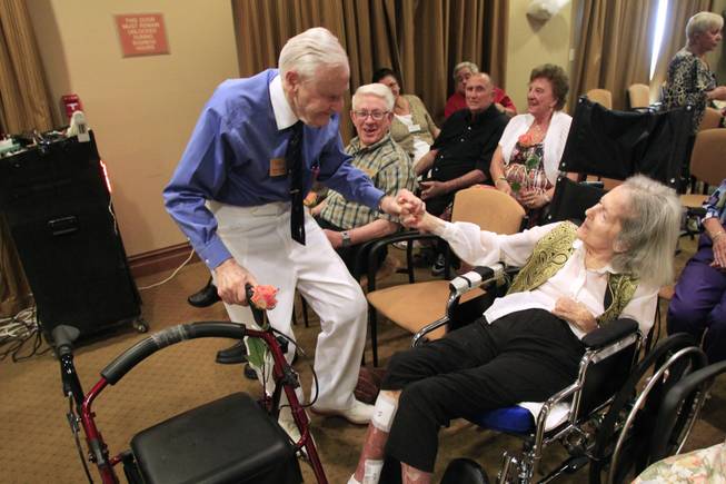 While Glenn Miller's "Chattanooga Choo Choo" plays, Herb Lowe holds his wife Bonnie's hand while he dances during a wedding vow renewal ceremony at Las Ventanas Wednesday, June 6, 2012. The Lowes have been married for 72 years.