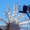 Workers put the finishing touches on a giant daisy for the Electric Daisy Carnival Thursday, June 7, 2012 at the Las Vegas Motor Speedway.