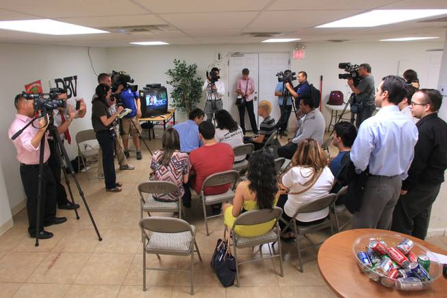 Media surround a small group gathered to listen to President Obama's announcement of new immigration reforms Friday, June 15, 2012 at the offices of the Progressive Leadership Alliance of Nevada.