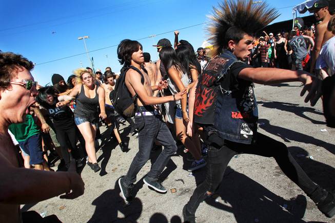 Fans form a mosh pit during the Las Vegas stop of the Vans Warped Tour Wednesday, June 20, 2012.