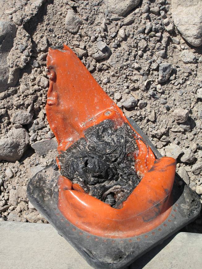 A melted cones near Wigwam Street is seen at the site of an early morning fire at an apartment construction site. Fire crews responded to an early morning fire at 1131 Wigwam, the future site of Theory Apartments on Wednesday , June 20, 2012.