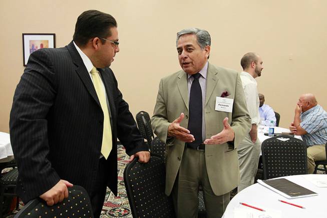 Stavan Corbett, left, president of the State Board of Education, speaks with Fernando Romero, regional field coordinator for the National Council of La Raza,during the English Mastery for Nevada's Prosperity education forum at the Stan Fulton Building on UNLV campus Thursday, June 21, 2012.