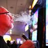 Tom Devenish smokes a cigar while playing the slots at the Eldorado Casino in downtown Henderson on Friday, June 22, 2012.