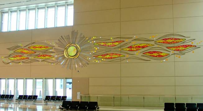 "Sunset Mirage" is a glass-and-metal sculpture by artists Barbara and Larry Domsky on display at Terminal 3. The county budgeted $5 million for Terminal 3 at McCarran Airport.