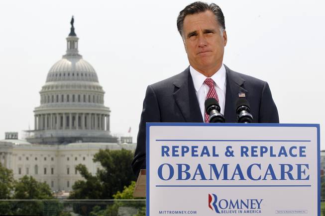 With the Capitol in the background, Republican presidential candidate Mitt Romney speaks about the Supreme Court's health care ruling, June 28.