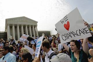Supporters of President Barack Obama's health care law celebrate outside the Supreme Court in Washington, Thursday, June 28, 2012, after the court's ruling was announced.