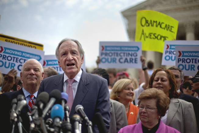 Senate Health, Education, Labor and Pensions Committee Chairman, Sen. Tom Harkin, D-Iowa, center, flanked by Sen. Benjamin Cardin, D-Md., left, and Sen. Barbara Mikulski, D-Md., speaks outside the Supreme Court in Washington, Thursday, June 28, 2012, after the court's ruling on President Barack Obama's health care law was announced.