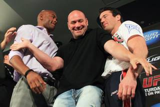 UFC president Dana White steps in to separate UFC middleweight champion Anderson Silva, left, and challenger Chael Sonnen as they face off after a news conference to promote their bout at UFC 148 Tuesday, July 3, 2012.