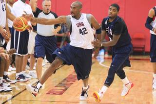 Kobe Bryant reaches for a ball while being guarded by Kyrie Irving during the USA Olympic basketball team practice Friday, July 6, 2012 at UNLV's Mendenhall Center.