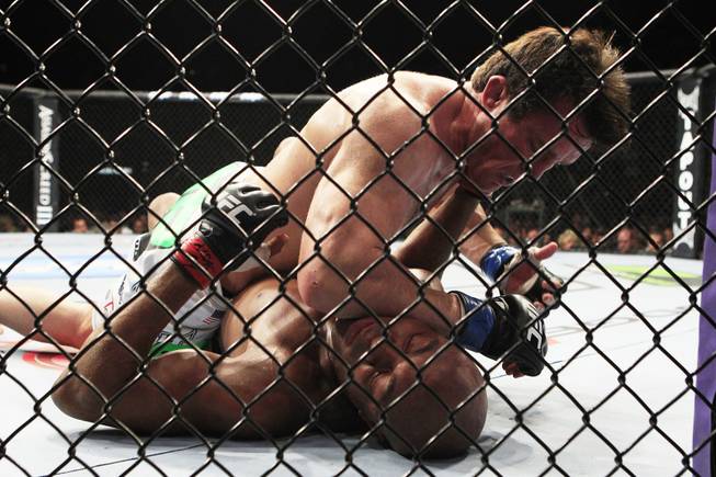 Chael Sonnen lands an elbow to the head of Anderson Silva during their bout at UFC 148 Saturday, July 7, 2012 at the MGM Grand Garden Arena.
