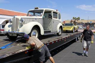 An HBO crew secures cars, once owned by Liberace, onto a car carrier at the Liberace Museum parking lot, Wednesday July 11, 2012. The cars, a 1972 custom Bradley GT and a 1957 London taxi, are on loan to HBO for a project called 