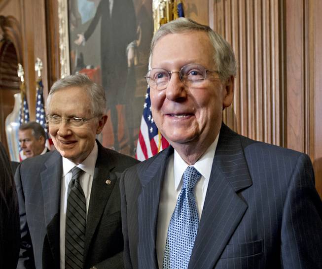 Senate Majority Leader Harry Reid of Nevada, left, and Senate Minority Leader Mitch McConnell of Kentucky attend a ceremony at the U.S. Capitol building on July 11, 2012, in Washington. 