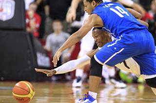 U.S. Olympic basketball team's Russell Westbrook and the Dominican Republic's Ronald Ramon lunge for a loose ball during their exhibition game Thursday, July 12, 2012 at the Thomas & Mack Center. The U.S. won 113-59.