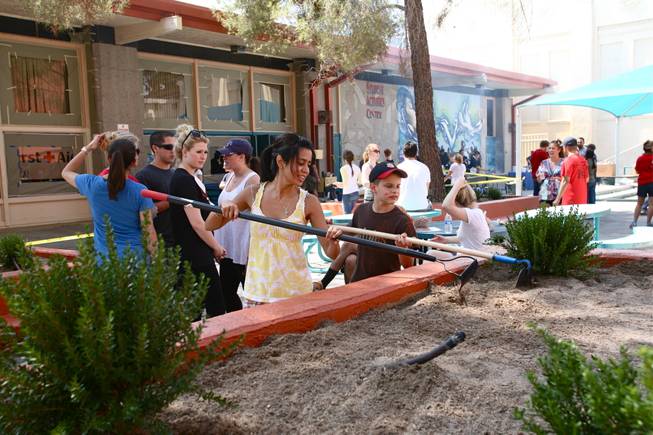 Volunteers refurbish planters and benches in the courtyard of Las Vegas Academy as part of the Downtown Cares day of service on Saturday, July 14, 2012. 