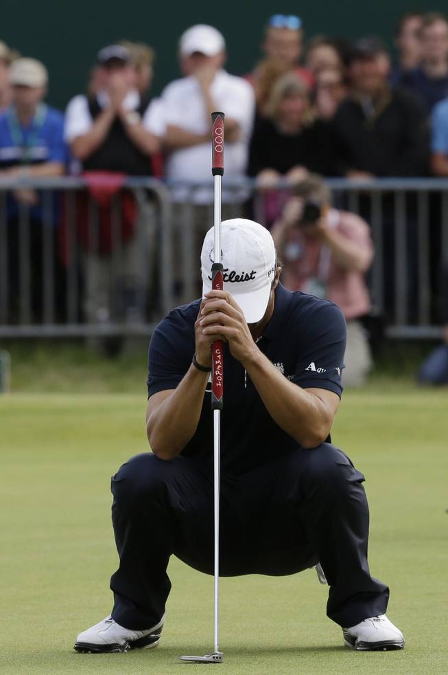 Adam Scott of Australia reacts after missing a putt on the 18th green at Royal Lytham & St Annes golf club during the final round of the British Open Golf Championship, Lytham St Annes, England Sunday, July 22, 2012.
