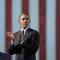 Photo: President Barack Obama looks back to applaud those