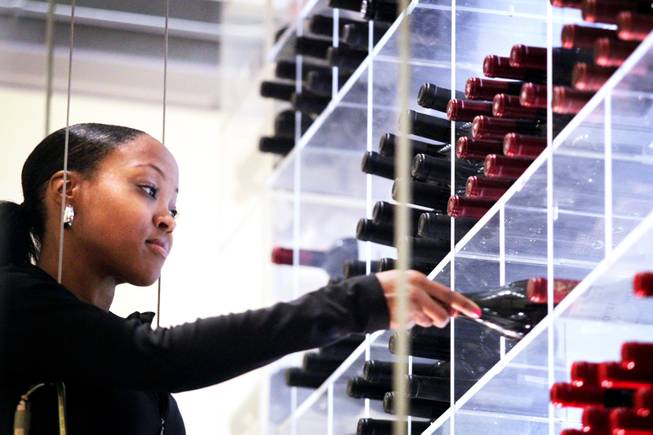 Wine angel Eboni Lomax demonstrate her technique for retrieving wine before dinner service at Aureole inside Mandalay Bay in Las Vegas on Friday, July 13, 2012.