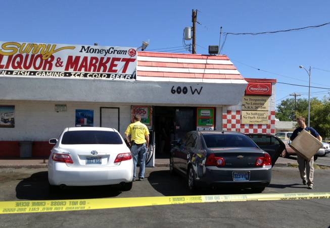Federal and state law enforcement authorities haul evidence out of Sunny Market, 600 W. Lake Mead Blvd., Wednesday morning, July 25, 2012. The store's owner, 54-year-old Amer "Sunny" Ramo, was charged in a criminal complaint with receipt, possession and purchase of contraband cigarrettes.