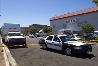 A police car blocks the road as federal and local law enforcement officials take artwork from a storage building in Boulder City, Nevada, about 20 miles southeast of Las Vegas, July 27, 2012. The seizure is apparently related to the arrest of German fugitive Ulrich Felix Anton Engler, 51, who was arrested in the Las Vegas area on July 25. Engler is accused of bilking investors of over $100 million using an Internet pyramid scheme.