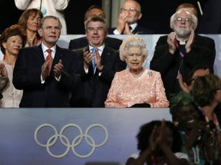 Britain's Queen Elizabeth II, center, the President of the International Olympic Committee Jacques Rogge, left, and Britain's Archbishop of Canterbury Rowan Williams, right, watch the Opening Ceremony at the 2012 Summer Olympics, Friday, July 27, 2012, in London. 