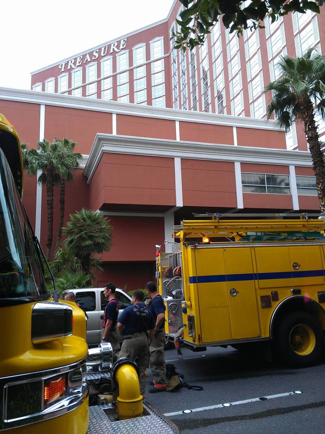 Clark County firefighters respond to a rooftop air conditioner fire atop Treasure Island that left 14 people with minor injuries Tuesday, July 31, 2012.
