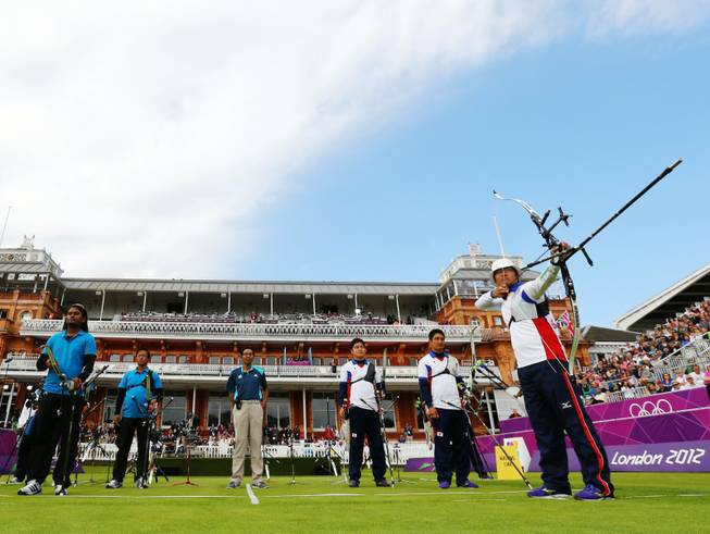 Japan's Takaharu Furukawa, right, competes in the men's team archery eliminations match against India during the 2012 Summer Olympics at Lord's Cricket Ground on Saturday, July 28, 2012, in London.  