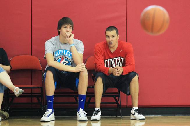 Former UNLV coach Justin Hutson talks with Bishop Gorman basketball player Stephen Zimmerman after the Rebels' open practice Saturday, Aug. 4, 2012.