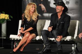 Faith Hill and Tim McGraw laugh while answering questions after announcing their concert series at the Venetian on Tuesday, Aug. 7, 2012.