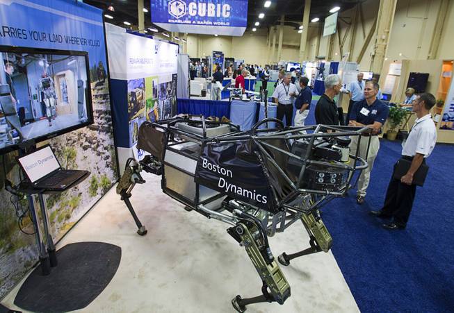 An LS3 robotic mule is displayed at the Boston Dynamics booth during the Association for Unmanned Vehicles Systems International (AUVSI) convention at the Mandalay Bay Thursday, Aug. 9, 2012. The mule, powered by a gasoline engine can carry a 400 lb. payload for 20 miles.