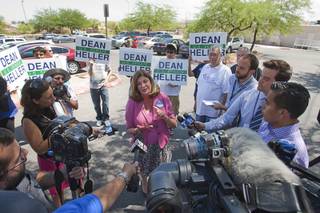 U.S. Congresswoman Shelley Berkley (D-NV) holds a  news conference in the parking lot of Palo Verde High School before a rally for Republican vice presidential candidate Paul Ryan at the school Tuesday, Aug. 14, 2012. Berkley is running for U.S. Senate against Sen. Dean Heller (R-NV). Heller supporters hold up signs in the background.