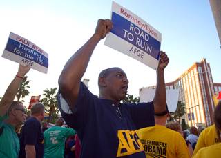 Robert Autrey, a member of the American Federation of Government Employees (AFGE), pickets against the Mitt Romney/Paul Ryan ticket in front of the Venetian on the Las Vegas Strip Tuesday, Aug. 14, 2012. Republican vice presidential candidate Paul Ryan was reportedly meeting privately with a small group of supporters at the casino owned by Sheldon Adelson, a billionaire and major donor to Republican campaigns.
