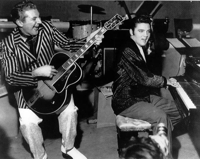 Piano virtuoso Liberace is shown playing the guitar with Elvis Presley at the piano in November 1956 at the Riviera Hotel in Las Vegas.  