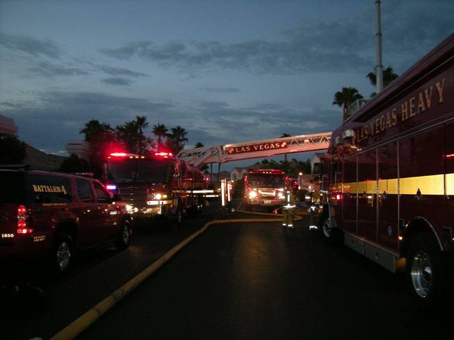 Fire trucks and equipment are shown in the predawn Thursday, Aug. 16, 2012, near 2957 Harbor Cove Drive, where a house sustained an estimated $200,000 damage in a fire.