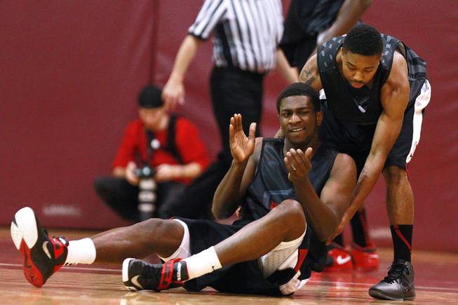 UNLV's Daquan Cook helps up teammate Savon Goodman during their game against the University of Ottawa at Montpetit Hall in Ottawa, Ontario Sunday, August 19, 2012. UNLV won the game 89-76. The Runnin' Rebels are in the midst of a four-game exhibition tour in Canada.