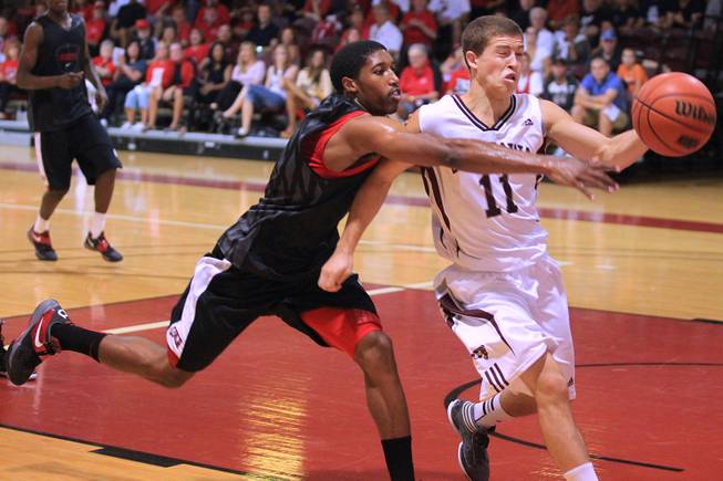 UNLV guard Justin Hawkins defends University of Ottawa guard Mike L'Africain during their game at Montpetit Hall in Ottawa, Ontario Sunday, August 19, 2012. UNLV won the game 89-76. The Runnin' Rebels are in the midst of a four-game exhibition tour in Canada.