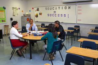 President Barack Obama holds a roundtable to discuss K-12 education with Clark County teachers Lori Elizabeth Henrickson, left, Isaac Barron and Claritssa Sanchez at Canyon Springs High School in North Las Vegas Wednesday, Aug. 22, 2012.