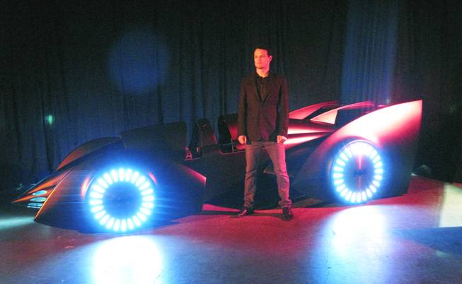 Actor Sam Heughan poses with a new version of the Batmobile that was unveiled at the UNLV Cox Pavillion in Las Vegas on Monday in advance of the arrival of "Batman Live" in October. Heughan stars as Batman in "Batman Live", a stage production that combines the classic story of the comic book super hero with high-flying acrobatics, pyrotechnics and an original score.