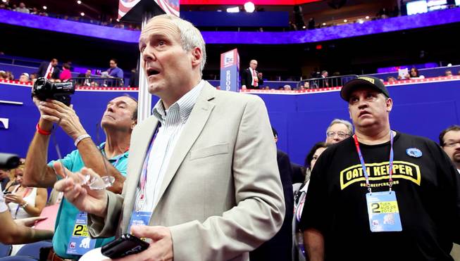 James Ayala, right, and Wayne Terhune look at the stage in disbelief as the rules they had been protesting are swiftly adopted Tuesday afternoon at the RNC, Aug. 28, 2012.