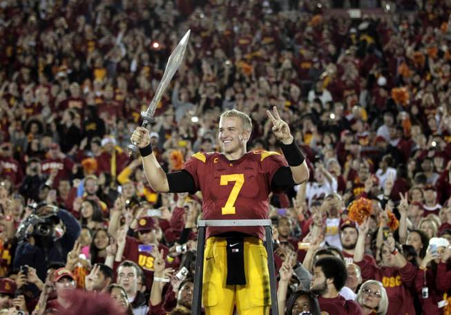 In this Nov. 26, 2011 file photo, Southern California quarterback Matt Barkley celebrates the Trojans' 50-0 win over UCLA in an NCAA college football game in Los Angeles.